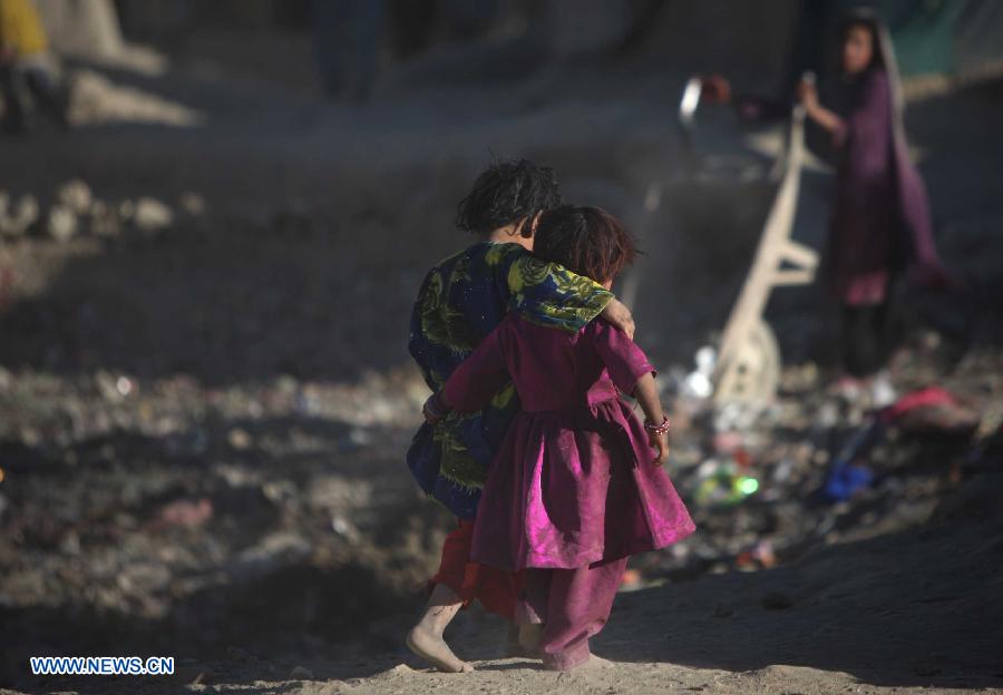 Displaced sisters are pictured outside their tent at a camp for displaced people in Kabul, Afghanistan, on Nov. 10, 2012. (Xinhua/Ahmad Massoud)