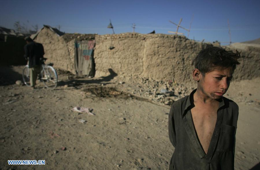 A displaced boy stands outside a tent at a camp for displaced people in Kabul, Afghanistan, on Nov. 10, 2012. (Xinhua/Ahmad Massoud)