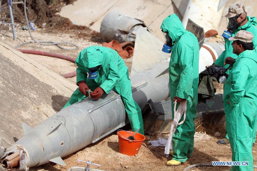 A team of Libyan experts and military engineers dismantles a rocket under the supervision of the United Nations, in Tripoli, Nov. 11, 2012. Experts were assigned to dump the toxic chemicals found in the air defense missiles and ammunition left over from the former Libyan leader Moamer Kadhafi's regime. (Xinhua/Hamza Turkia) 