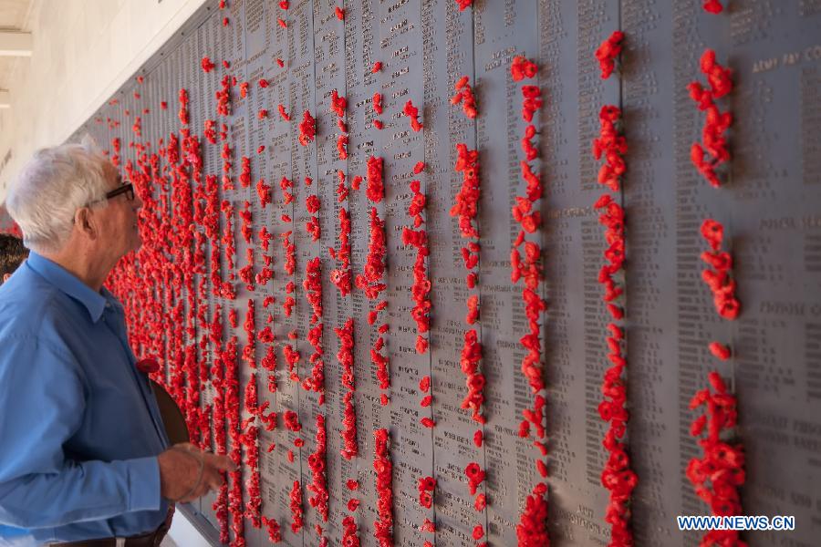 A man looks at the wall showing the names of martyrs in the War Memorial in Canberra, Australia, Nov. 11, 2012. Ceremonies marking the 11th hour of the 11th day of the 11th month, remember the moment in 1918 when the guns of the World War I fell silent. (Xinhua/Justin Qian)