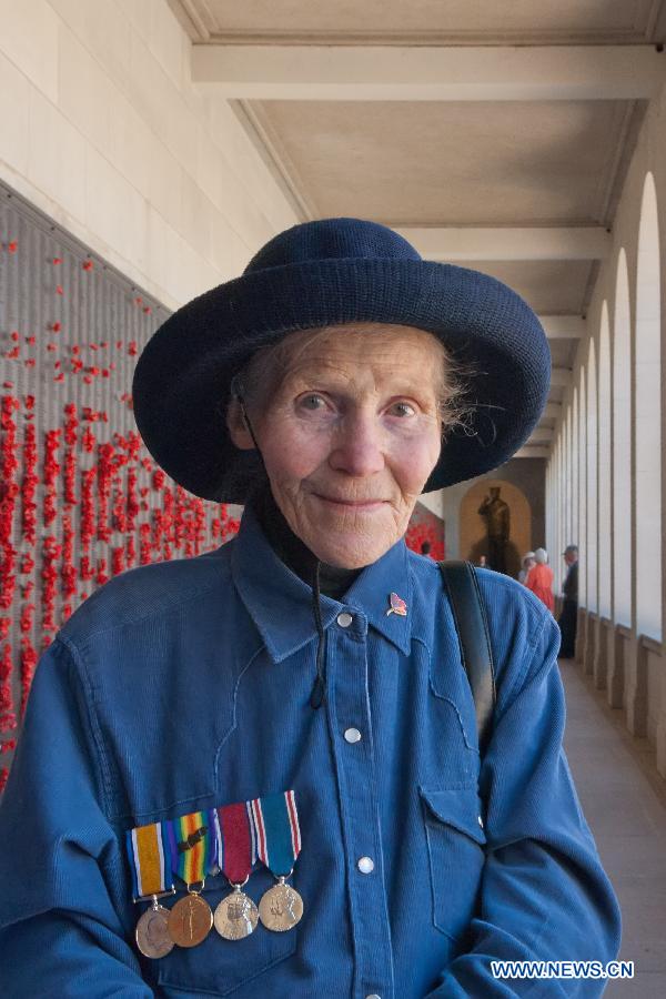 A woman wearing her father's medals from the World War I visits the War Memorial in Canberra, Australia, Nov. 11, 2012. Ceremonies marking the 11th hour of the 11th day of the 11th month, remember the moment in 1918 when the guns of the World War I fell silent. (Xinhua/Justin Qian)