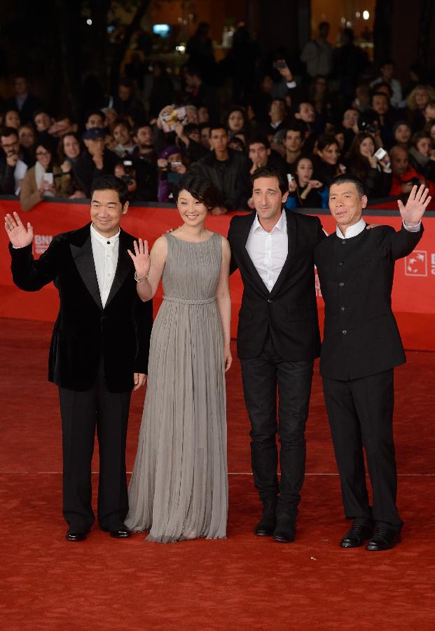 Chinese director Feng Xiaogang, actors Adrien Brody, Xu Fan and Zhang Guoli (from R to L) pose on the red carpet for the premiere of the film "Back to 1942" at the 7th Rome Film Festival in Rome, capital of Italy, late Nov. 11, 2012. (Xinhua/Wang Qingqin)