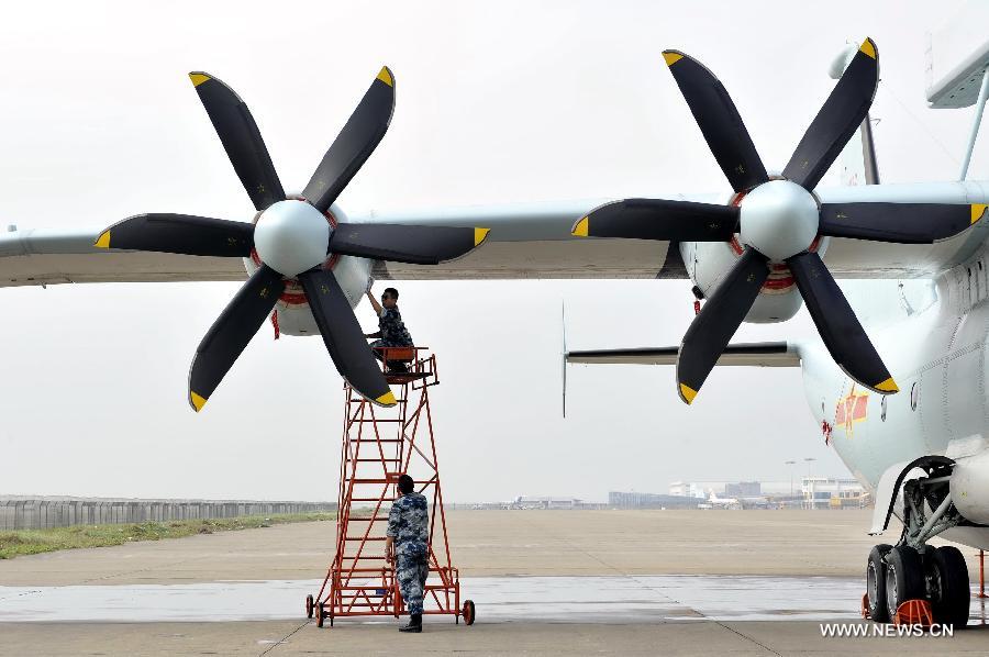Maintenance staff members of Bayi Aerobatic Team of the People's Liberation Army (PLA) Air Force, check a plane in Zhuhai, south China's Guangdong Province, Nov. 12, 2012. The 9th China International Aviation and Aerospace Exhibition will kick off on Tuesday in Zhuhai. (Xinhua/Liang Xu) 