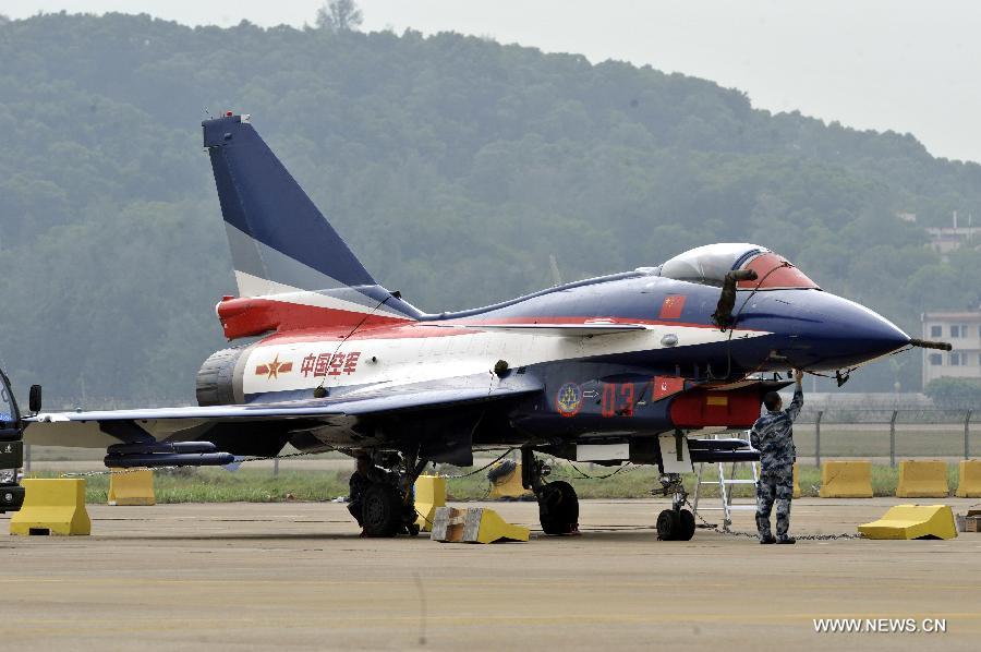 A maintenance staff member of Bayi Aerobatic Team of the People's Liberation Army (PLA) Air Force, checks a plane in Zhuhai, south China's Guangdong Province, Nov. 12, 2012. The 9th China International Aviation and Aerospace Exhibition will kick off on Tuesday in Zhuhai. (Xinhua/Liang Xu) 