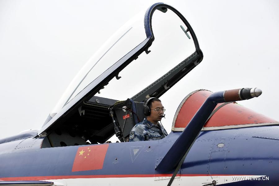 A maintenance staff member of Bayi Aerobatic Team of the People's Liberation Army (PLA) Air Force, checks a plane in Zhuhai, south China's Guangdong Province, Nov. 12, 2012. The 9th China International Aviation and Aerospace Exhibition will kick off on Tuesday in Zhuhai. (Xinhua/Liang Xu)