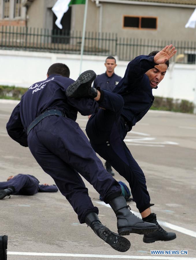 Algerian police students show their combat skills during the graduation ceremony, in Algiers, Algeria, on Nov. 12, 2012. A graduation ceremony was held Monday in the police academy in Ain Benian. (Xinhua/Mohamed Kadri)