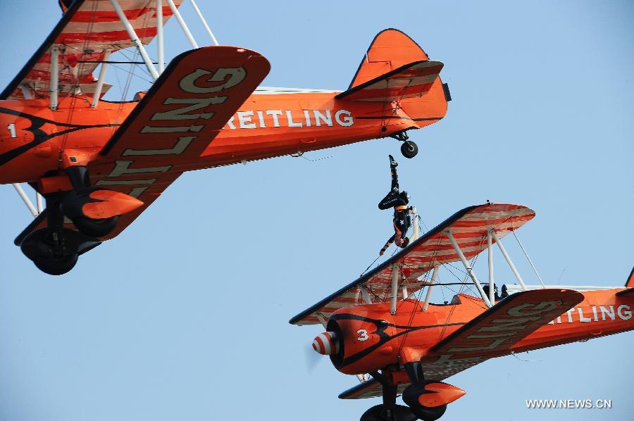 Members of Breitling Wingwalkers, a famous European aerobatic team, perform during a test flight in Zhuhai, south China's Guangdong Province, Nov. 11, 2012. The 9th China International Aviation and Aerospace Exhibition will kick off on Tuesday in Zhuhai. Breitling Wingwalkers is known for its acrobats who perform on the wings of Boeing Stearman biplanes in mid-air. (Xinhua/Yang Guang) 