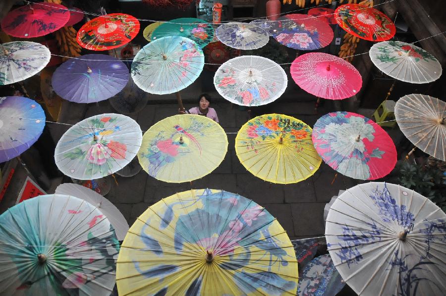 Photo taken on Nov. 12, 2012 shows oil-paper umbrellas at a workshop in Xixiu District of Anshun City, southwest China's Guizhou Province. Made of oiled paper and bamboo frame, oil-paper umbrella is a traditional Chinese handicraft. The skills of making oil-paper umbrellas were introduced to Guizhou in early Ming Dynasty (1368-1644). (Xinhua/Huang Yong) 