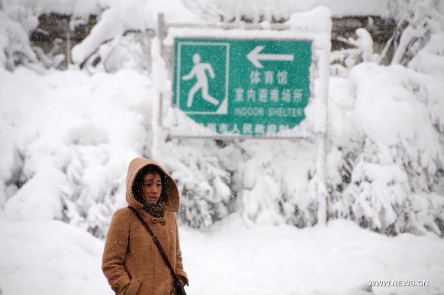 A citizen walks on the snow-covered road in Hegang, northeast China's Heilongjiang Province, Nov. 13, 2012. The city witnessed an intense snowfall since Nov. 11. (Xinhua/Wang Kai) 