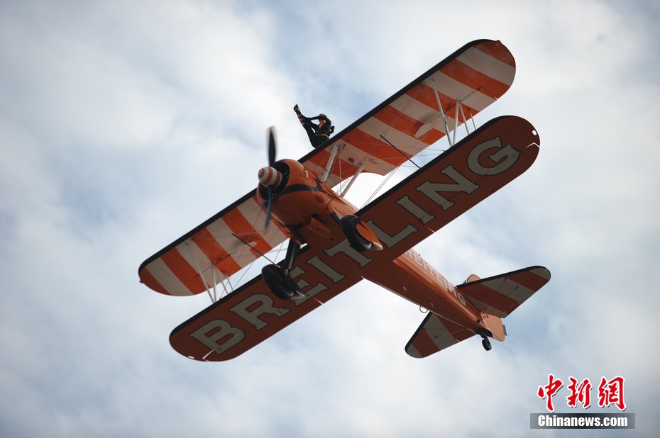 Photo taken on Nov. 11, 2012 shows the wingwalkers of Beritling Jet Tem, a famous European aerobatic team, putting on wonderful performance on the wings of biplaines during a test flight for the Airshow China 2012. The airshow kicked off on Tuesday morning in south China’s Zhuhai. (Photo/Chinanews.com)