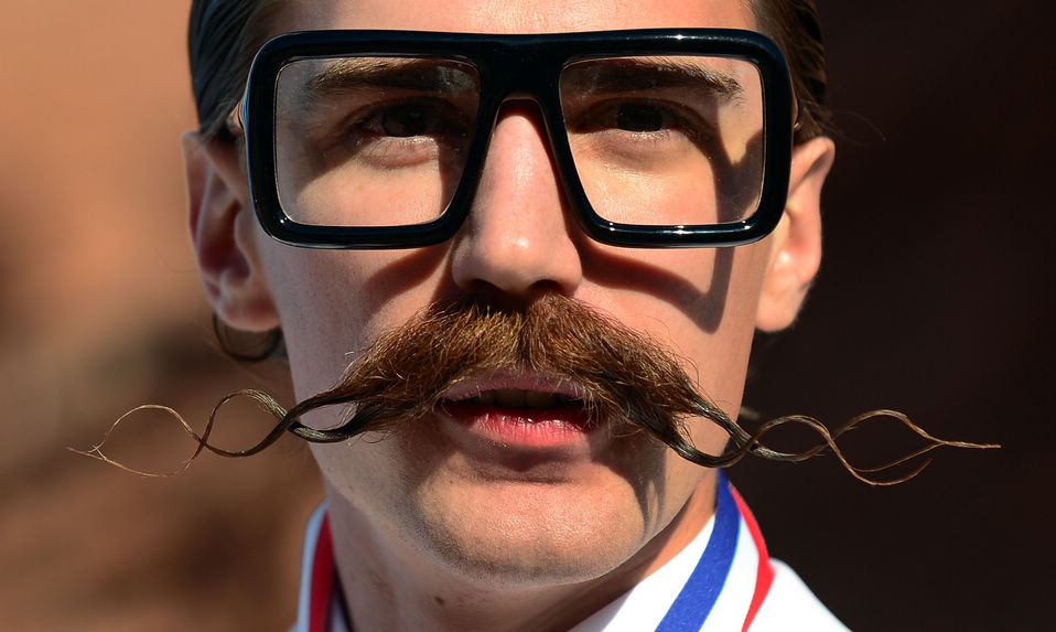 A contestant poses after winning first place in the Freestyle Moustache category at the third annual National Beard and Moustache Championships in Las Vegas, Nevada on November 11, 2012. (Xinhua/AFP)