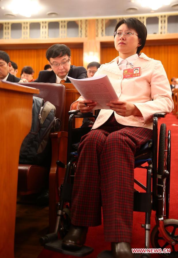 Hou Jingjing, a delegate to the 18th National Congress of the Communist Party of China (CPC), attends the opening ceremony of the 18th CPC National Congress at the Great Hall of the People in Beijing, capital of China, Nov. 8, 2012.