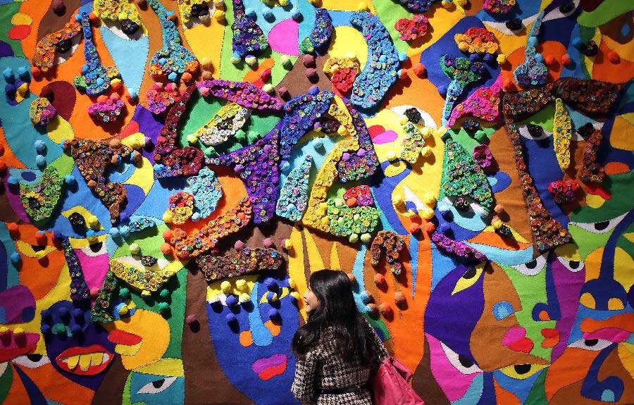 A visitor views artworks at the 7th International Fiber Art Biennale and Symposium in Nantong, east China's Jiangsu Province, Nov. 12, 2012. More than 300 artworks from 37 countries and regions were displayed during the exhibition, which was slated from Nov. 8 to Dec. 5. (Xinhua/Huang Zhe) 