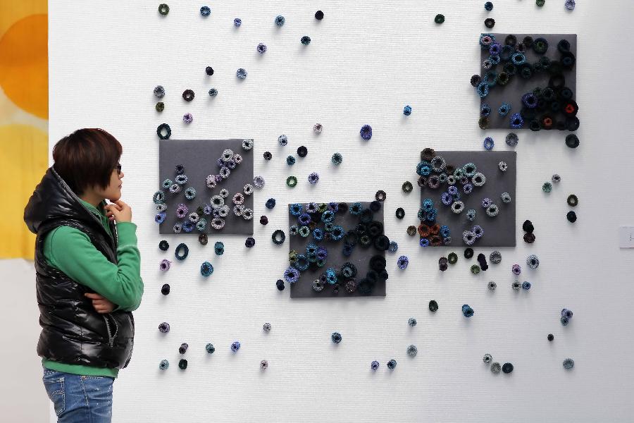 A visitor views artworks at the 7th International Fiber Art Biennale and Symposium in Nantong, east China's Jiangsu Province, Nov. 12, 2012. More than 300 artworks from 37 countries and regions were displayed during the exhibition, which was slated from Nov. 8 to Dec. 5. (Xinhua/Huang Zhe) 