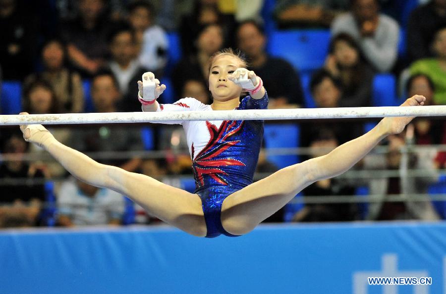 Sung Jihye of South Korea competes during the the uneven bars contest of the women's all around competition at the 5th Artistic Gymnastics Asian Championships in Putian, city of southeast China's Fujian Province, on Nov. 12, 2012. Sung won the silver medal with 56.900. (Xinhua/Wei Peiquan) 