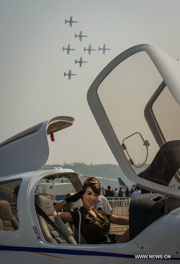 A model poses in an aircraft's cockpit during the 9th China International Aviation and Aerospace Exhibition in Zhuhai, south China's Guangdong Province, Nov. 13, 2012. (Xinhua/Liu Dawei) 