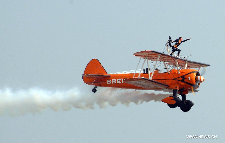 A member of Breitling Wingwalkers, a famous European aerobatic team, performs during the 9th China International Aviation and Aerospace Exhibition in Zhuhai, south China's Guangdong Province, Nov. 13, 2012. (Xinhua/Zhang Chaoxiang) 