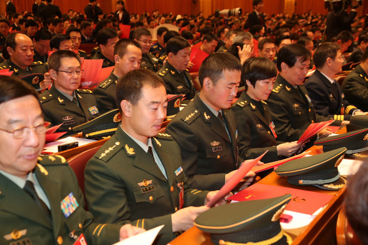 Delegates watch their ballots during the closing session of the 18th National Congress of the Communist Party of China (CPC) at the Great Hall of the People in Beijing, capital of China, Nov. 14, 2012. (Xinhua/Liu Jiansheng)