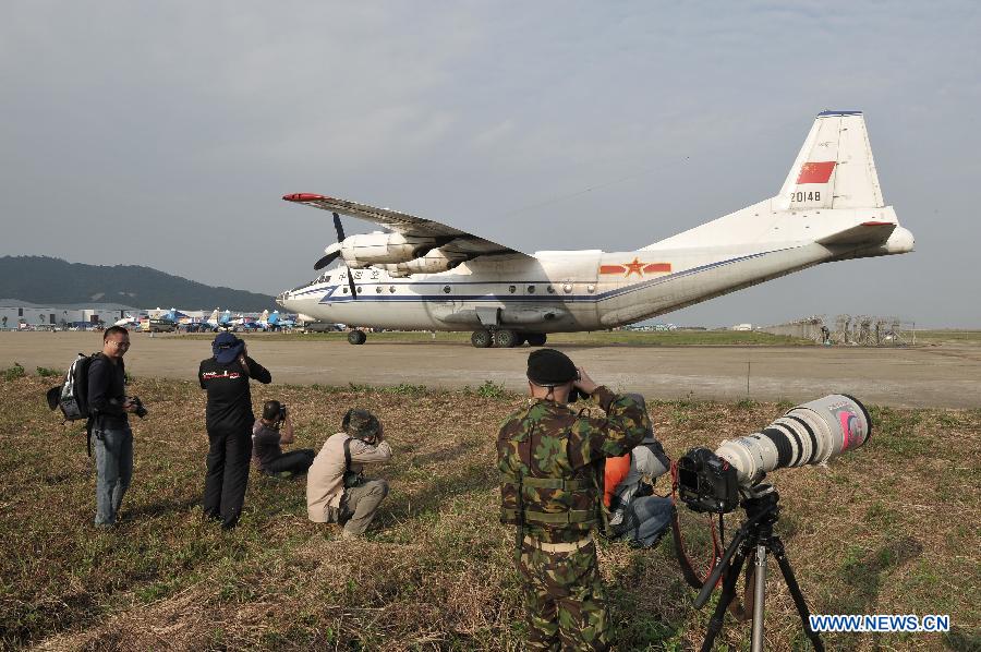 Photographers take photo of a transport aircraft from China Air Force during the 9th China International Aviation and Aerospace Exhibition in Zhuhai, south China's Guangdong Province, Nov. 11, 2012. The exhibition has attracted a large number of photograghers. Some of them are from media, some are from aviation industry corporations and others are big fans of aviation. (Xinhua/Yang Guang)