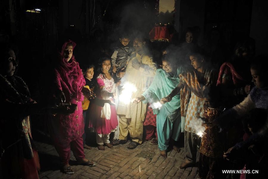 Pakistani Hindus play with fireworks to celebrate the Hindu festival of Diwali, in eastern Pakistan's Lahore, on Nov. 13, 2012. People light lamps and offer prayers to the goddess of wealth Lakshmi in the Hindu festival of Diwali, the festival of lights, which falls on Nov. 13 this year. (Xinhua/Sajjad)