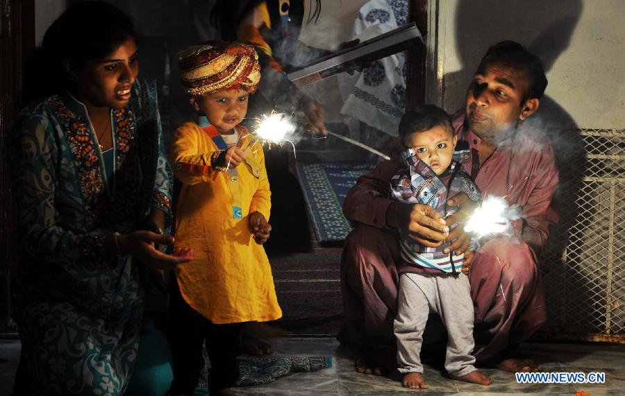 Pakistani Hindu children play with fireworks to celebrate the Hindu festival of Diwali, in southern Pakistani port city of Karachi, on Nov. 13, 2012. People light lamps and offer prayers to the goddess of wealth Lakshmi in the Hindu festival of Diwali, the festival of lights, which falls on Nov. 13 this year. (Xinhua/Masroor)