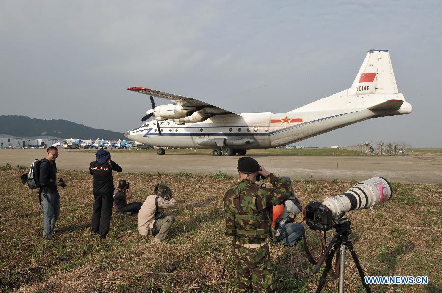 Photographers take photo of a transport aircraft from China Air Force during the 9th China International Aviation and Aerospace Exhibition in Zhuhai, south China's Guangdong Province, Nov. 11, 2012. The exhibition has attracted a large number of photograghers. Some of them are from media, some are from aviation industry corporations and others are big fans of aviation. (Xinhua/Yang Guang)