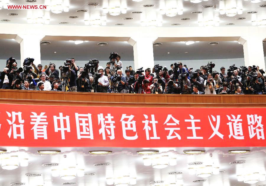 Journalists cover the closing session of the 18th National Congress of the Communist Party of China (CPC) at the Great Hall of the People in Beijing, capital of China, Nov. 14, 2012. (Xinhua/Liu Weibing)