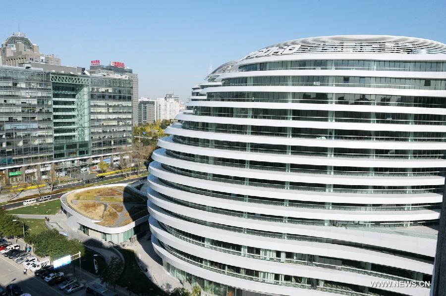 Photo taken on Nov. 14, 2012 shows the exterior of Galaxy Soho building in Beijing, capital of China. The newly-built building, desigened by Iraqi-British architect Zaha Hadid, is a 330,000-square-meter office, retail and entertainment complex. (Xinhua/Hu Qingming) 