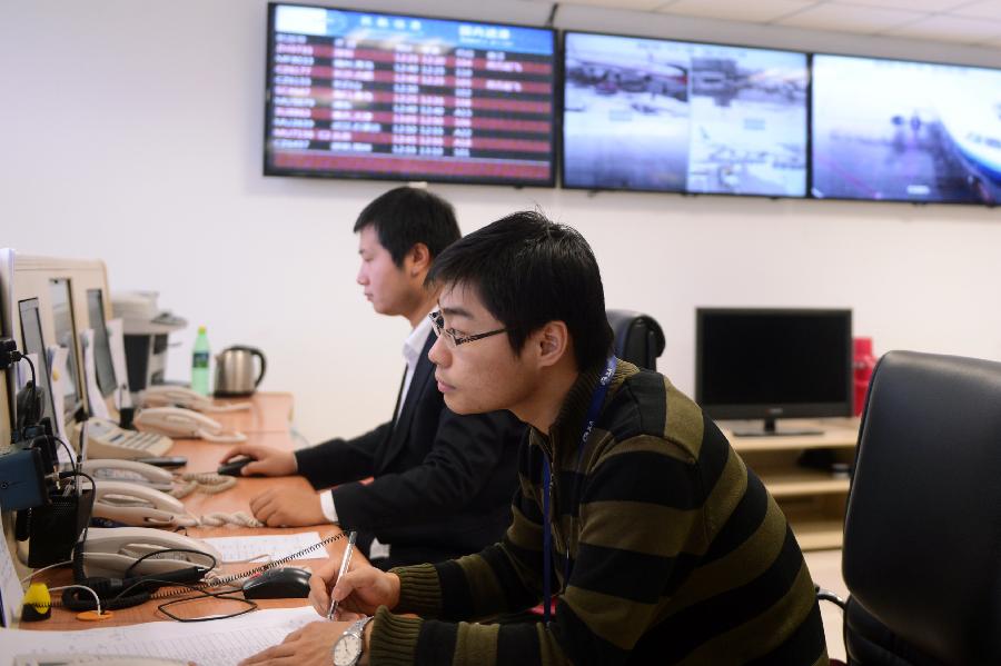 Staffers work in the control tower in Changchun Longjia International Airport in Changchun, capital of northeast China's Jilin Province, Nov. 14, 2012. Most of flights departing from and arriving at the airport were not affected by the heavy snowstorm that precipitated from Sunday until Tuesday. (Xinhua/Lin Hong) 