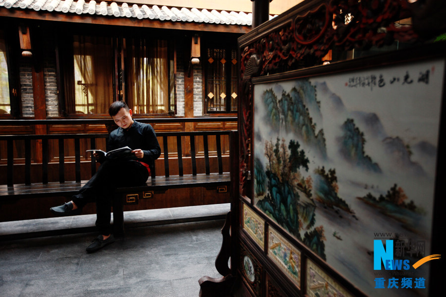 Liu reads a fashion magazine in the Shouzuo Mansion in Chongqing on Oct. 18, 2012.