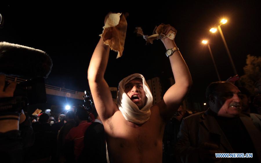 A protester takes part in a demonstration following an announcement that Jordan would raise fuel prices in Amman, Jordan, Nov. 13, 2012. At least ten policemen were shot and four other civilians injured during riots across Jordan late Tuesday and Wednesday after the government ended fuel subsidies, the state-run Petra news agency reported. (Xinhua/Mohammad Abu Ghosh)