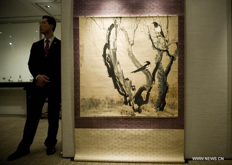 A staff member stands beside a painting of Xu Beihong on a press conference of the Christie's autumn auction preview event in south China's Hong Kong, Nov. 14, 2012. The auction will be held in Hong Kong from Nov. 24 to Nov. 28. (Xinhua/Lui Siu Wai) 