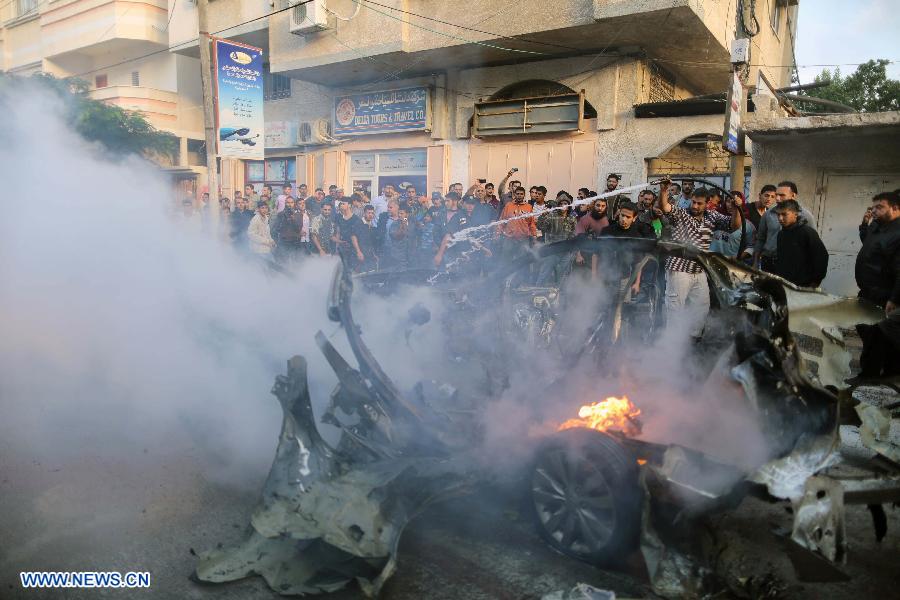 Emergency services extinguish the burned out car of Qassam top leader Ahmed Jabari after an Israeli air strike in Gaza City, Nov. 14, 2012. Hamas says the head of its military wing Ahmed al-Jaabari has been killed in an Israeli air strike. Israel said it had targeted Ahmed al-Jaabari because of what it called his terrorist activity. Seven Palestinians were killed following a series of Israel's airstrikes on Gaza city, and more than 40 others wounded, government's emergency services in the Gaza Strip said. (Xinhua/Wissam Nassar)