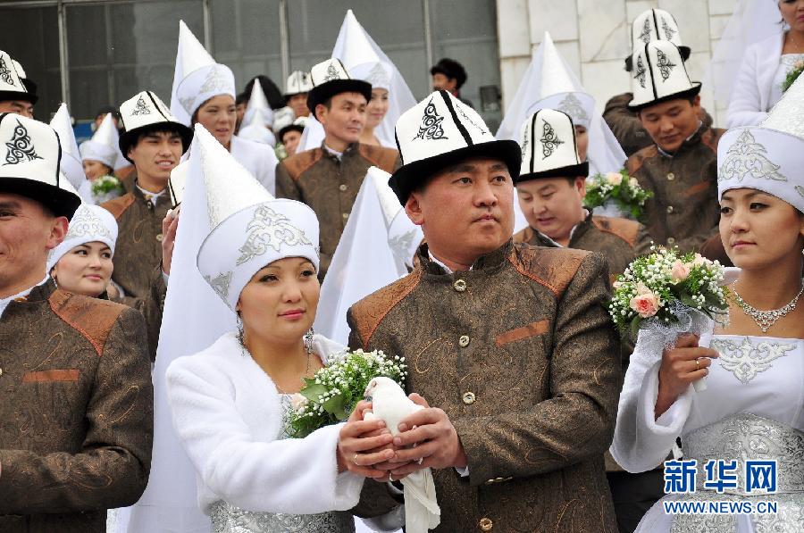 Kyrgyz brides and grooms lay flowers at the Eternal Flame before a mass wedding ceremony in Bishkek, Kyrgyzstan on May 13, 2011. (Xinhua/Luo Man)
