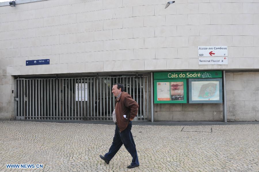 A man walks past a closed subway station during a general strike in Lisbon, Portugal, on Nov. 14, 2012. (Xinhua/Zhang Liyun)