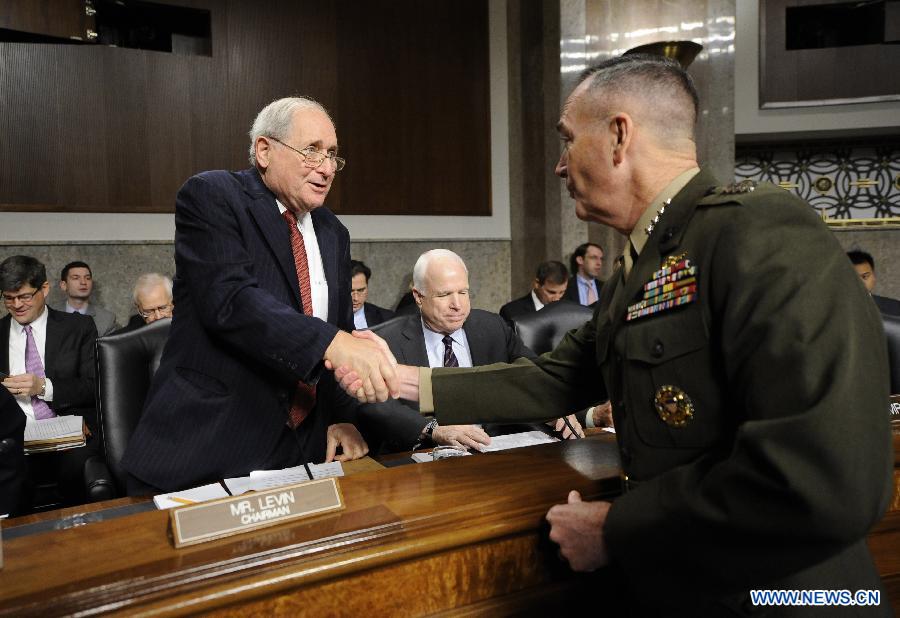 U.S. Marine General Joseph Dunford (R) greets Chairman Carl Levin (L, Democrat) and ranking member John McCain (Republican) during his confirmation hearing before the Senate Armed Service Committee on Capitol Hill in Washington D.C., capital of the United States, Nov. 15, 2012. (Xinhua/Zhang Jun)