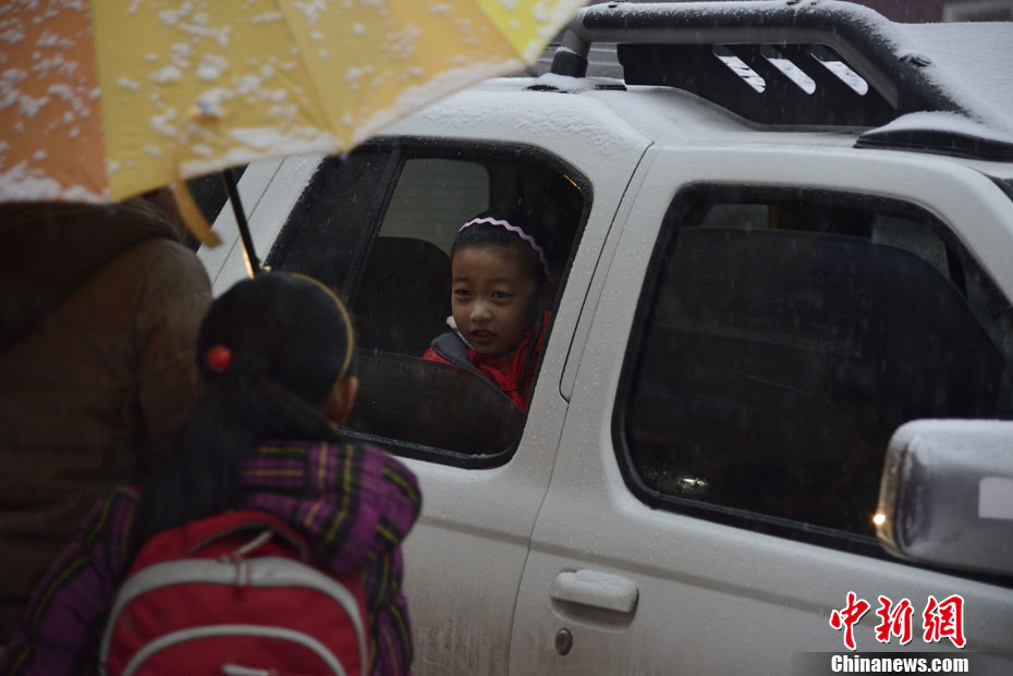 Pictures shows parents picking up children after school in snow in Hohhot on Nov. 15, 2012.(Chinanews/Liu Wenhua)