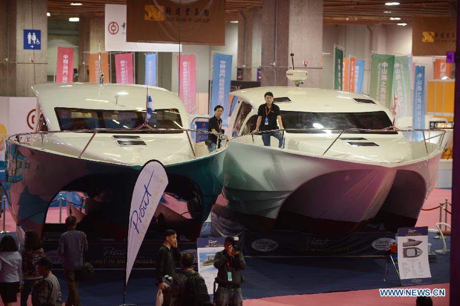 Visitors view yachts during the 2012 Macao Yacht Show in Macao, south China, Nov. 16, 2012. More than 30 yacht exhibitors take part in the three-day yacht show, which kicked off here on Friday. (Xinhua/Cheong Kam Ka)