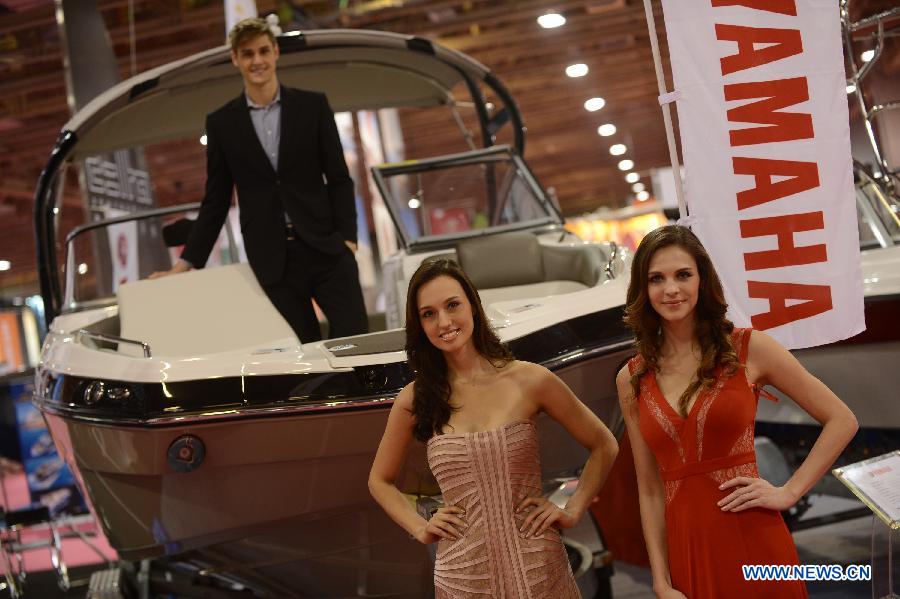 Models present a yacht during the 2012 Macao Yacht Show in Macao, south China, Nov. 16, 2012. More than 30 yacht exhibitors take part in the three-day yacht show, which kicked off here on Friday. (Xinhua/Cheong Kam Ka)