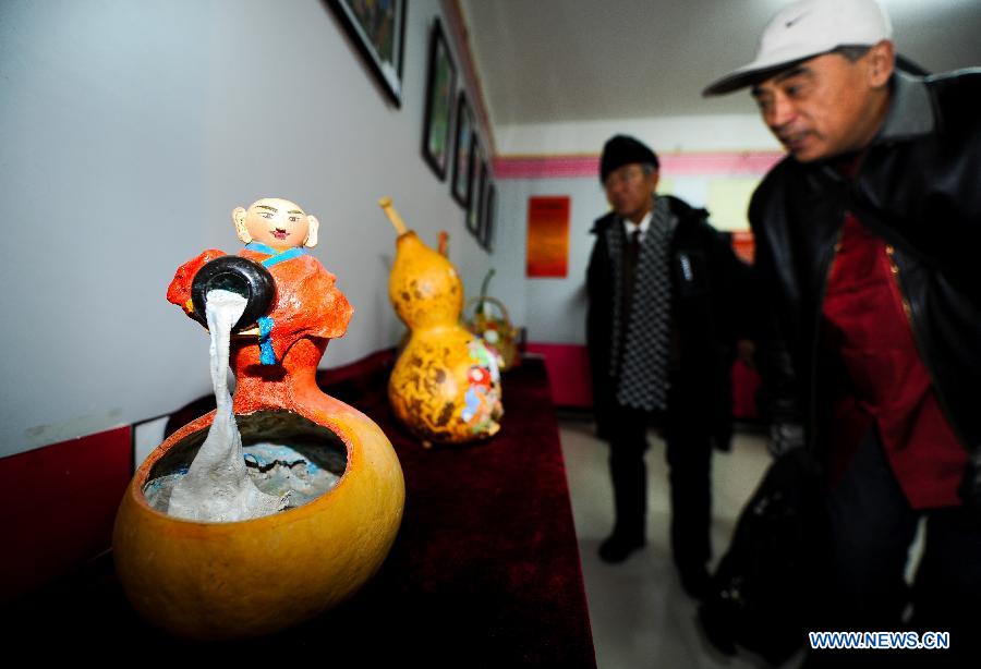 Visitors view artworks presented during an exhibition on the folk painting in Changchun, capital city of northeast China's Jilin Province, Nov. 16, 2012. (Xinhua/Xu Chang) 