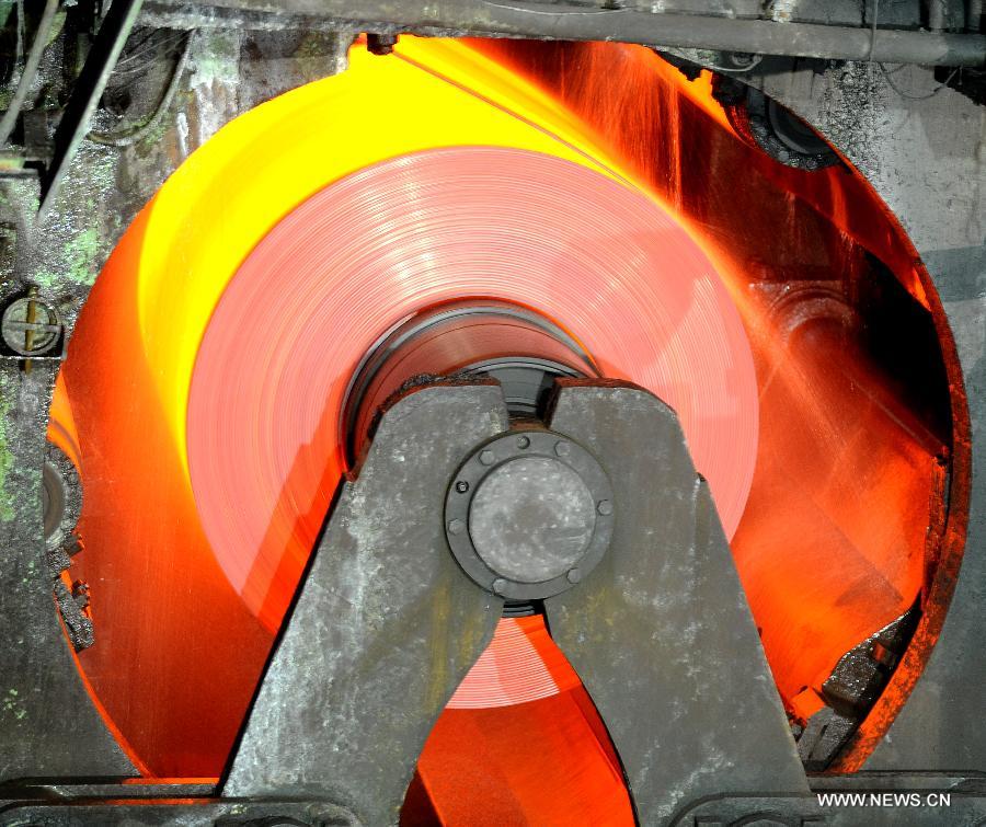 A stainless steel coil is processed in Taiyuan Iron & Steel (Group) Company (TISCO) in Taiyuan, capital of north China's Shanxi Province, Oct. 17, 2012. Against the backdrop of sluggish steel industry, TISCO, the world's largest stainless steel enterprise, has optimized product structure with technical innovation, and managed to achieve revenue of 105.541 billion yuan (about 16.88 billion U.S. dollars) in the first three quarters of 2012, with a year-on-year growth rate of 11.4%. (Xinhua/Yan Yan) 