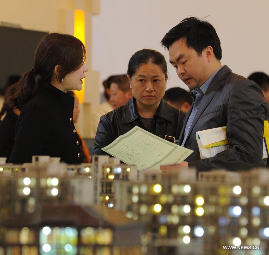 Residents look at building models at a real estate trade fair in Guiyang, capital of southwest China's Guizhou Province, Nov. 17, 2012. (Xinhua/Tao Liang) 
