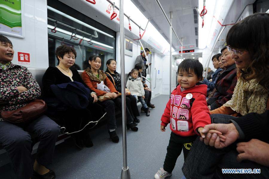 Passengers take a test ride on the soon-to-open Metro Line 1 in Hangzhou, capital of east China's Zhejiang Province, Nov. 18, 2012. 600,000 residents and journalists are invited for a test ride from Sunday to Wednesday on the newly built metro line. (Xinhua/Ju Huanzong) 