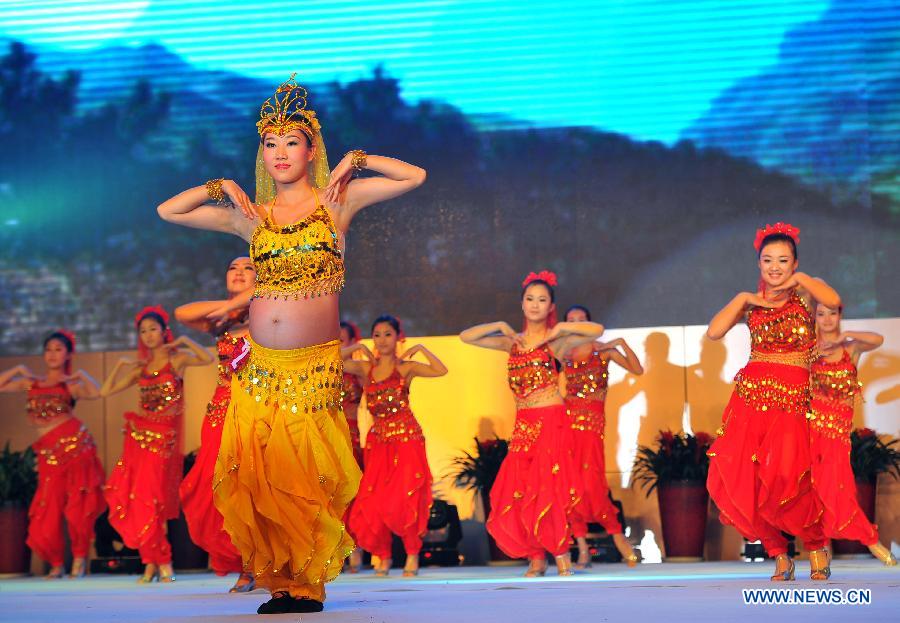A pregnant woman (front) dances at a mothers-to-be pageant in Taiyuan, capital of north China's Shanxi Province, Nov. 18, 2012. A total of 35 expectant mothers attended the pageant which was held on Sunday. (Xinhua/Yan Yan) 