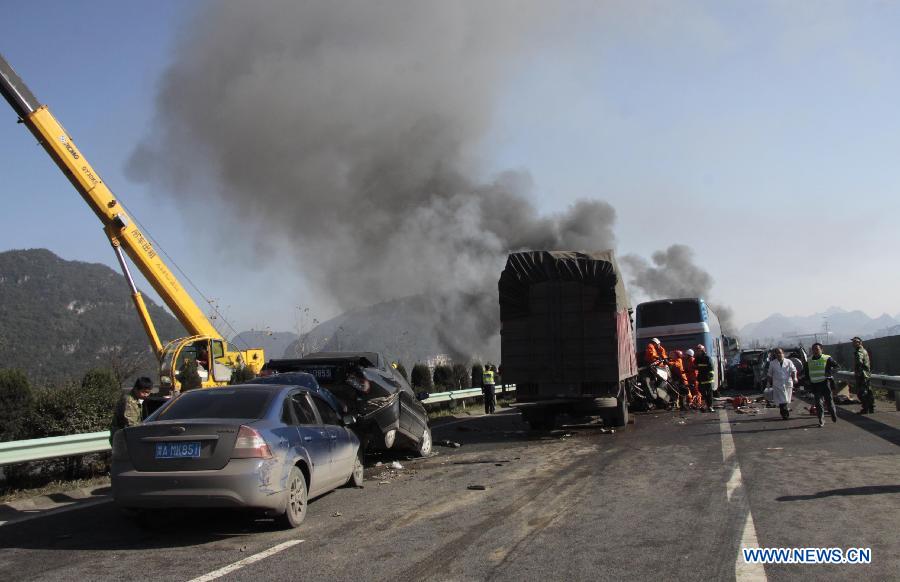 Photo taken on Nov. 17, 2012 shows a traffic accident site on the Shanghai-Kunming expressway in Anshun City, southwest China's Guizhou Province. The pileup accident occurred at about 9 a.m. Saturday on the Hukun (Shanghai - Kunming) expressway in Anshun City, leaving nine people dead and 19 others injured. More than 25 vehicles involved in the accident, and seven of them burst into flames. (Xinhua/Tao Xuede)