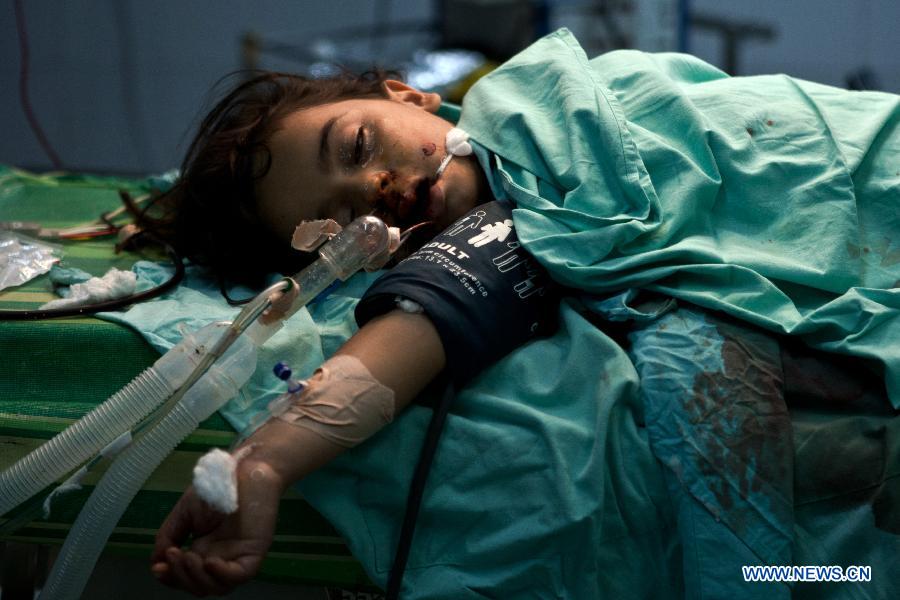 A wounded Palestinian girl receives treatment in al-aqsa hospital after an Israeli air strike in the Central Gaza Strip, on Nov. 18, 2012. Three Palestinian children were killed in Israeli air strikes on Sunday, hospital officials said. Israel bombed militant targets in Gaza for the fifth straight day on Sunday, launching aerial and naval attacks as its military prepared for a possible ground invasion. (Xinhua/Chen Xu) 