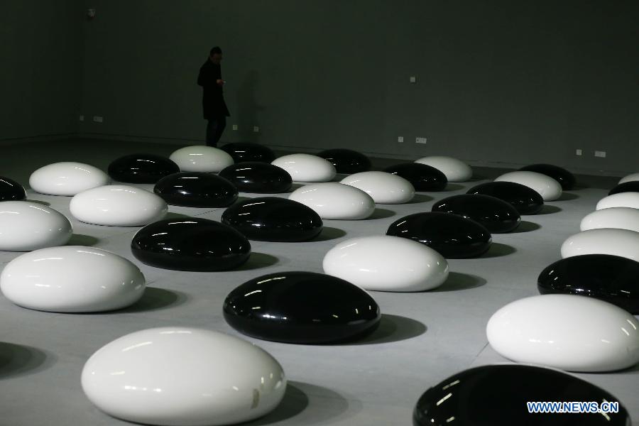 A visitor walks among huge chess pieces at the art exhibition "I Love Aijing" in the National Museum of China in Beijing, China, Nov. 19, 2012. The art exhibition, showcasing Ai Jing's creations, kicked off here Monday. Ai Jing, a pop singer who won her fame in 1990s, has been involved in artwork exhibition since 2007, showing her work in Beijing, Shanghai and New York. (Xinhua/Ren Zhenglai) 