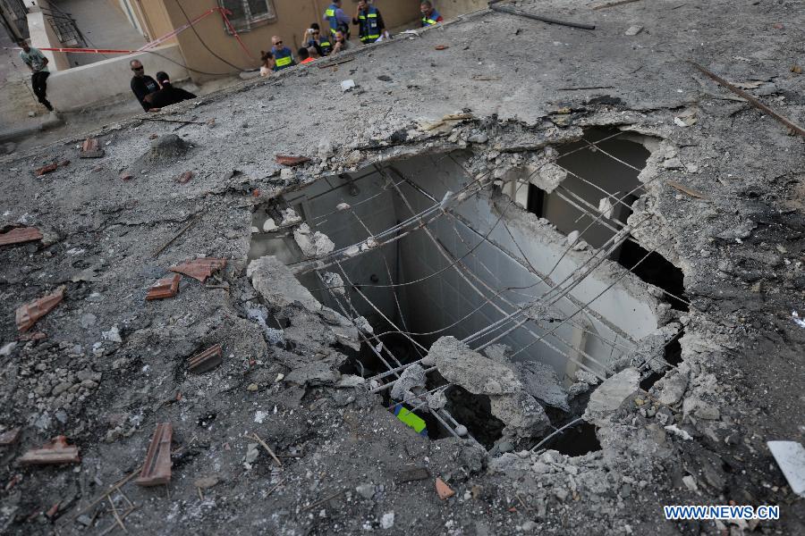 A house is damaged by mortar rocket fired from the Gaza Strip, in Ofakim, South Israel, on Nov.19, 2012. Rocket fire against Israel resumed Monday morning. (Xinhua/Yin Dongxun) 