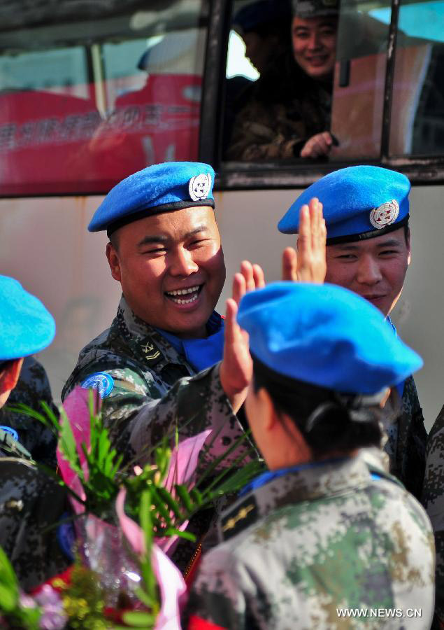 Members of the medical team of the 14th batch of Chinese peacekeeping force for Liberia bid farewell to colleagues during a departure ceremony in Tianjin, north China, Nov. 13, 2012. The first batch of a 43-member Chinese medical personnel group left for Liberia on a eight-month UN peacekeeping mission here on Tuesday. (Xinhua/Zhang Chaoqun)