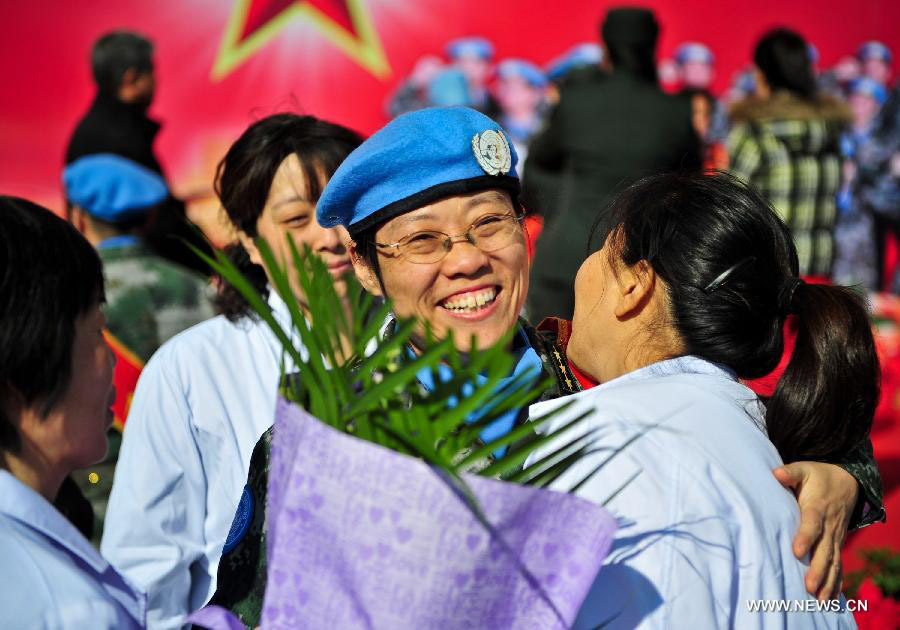 A member of the medical team of the 14th batch of Chinese peacekeeping force for Liberia bids farewell to her colleague during a departure ceremony in Tianjin, north China, Nov. 13, 2012. The first batch of a 43-member Chinese medical personnel group left for Liberia on a eight-month UN peacekeeping mission here on Tuesday. (Xinhua/Zhang Chaoqun) 